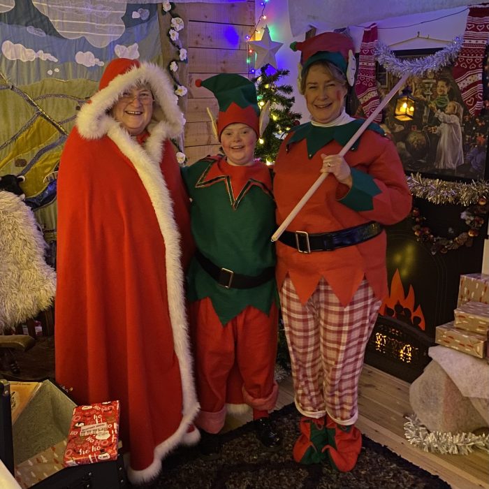 three people dressed in christmas wear